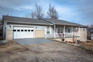 Well kept and ready for you to move in! This 3 bed, 2 1/2 bath, home sits on nearly 2 acres on pavement. Also features a large covered deck, paved driveway, garage, carport, and outbuildings.