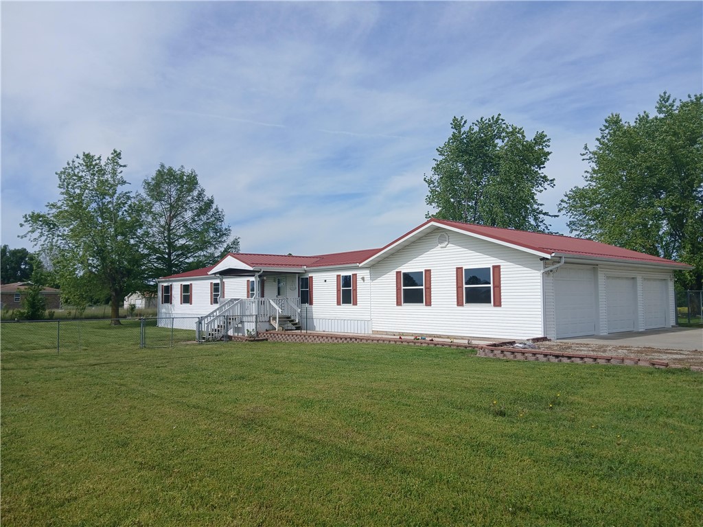 Large Manufactured home offers 4 bedrooms, 2.5 baths on a permanent foundation. RV parking Pad, fantastic sunsets from the Back deck and a small shop building with electrical and plumbing. Fenced in back yard at both front and back, Large 2 car garage and plenty of outdoor parking