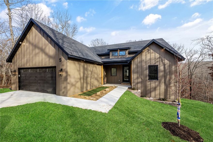 A hole-in-one for buyers seeking a thoughtfully designed home in an established neighborhood within the Bentonville School District. Tucked away on a cul-de-sac, this home is ideally situated between Highlands Golf Course and Scotsdale Golf Course, with Bella Vista Country Club just minutes away. Inside, abundant natural light fills the split 3-bedroom, 2-bath floor plan, featuring a spacious primary suite complete with a large soaking tub. Additional highlights include a walk-in laundry room with a butler’s pantry, propane cooktop, pocket office, and prewiring for sound and security. Outdoor living is just as inviting, with a large covered deck and the unique charm of a front-yard putting green. A 1-year builder’s warranty is included for added peace of mind.