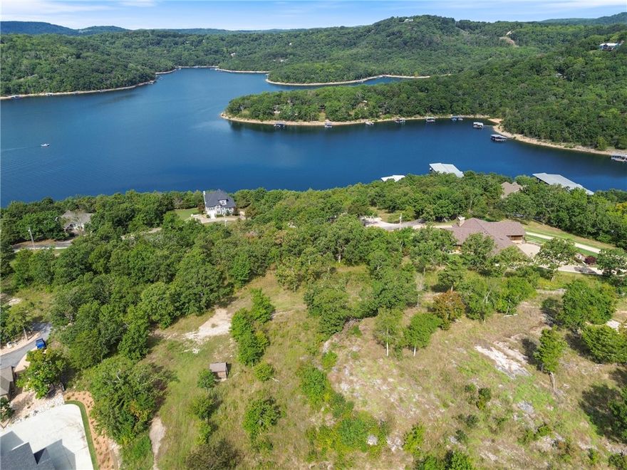 The perfect opportunity to own a stunning +/- 2.05 acre wooded lot in the highly sought-after gated community of Del Lago. Nestled in a private setting, this property offers breathtaking views of Beaver Lake and includes access to a boat dock and dedicated slip, making it an ideal location for building your dream home or a peaceful lake retreat. Utilities are conveniently available at the street, including electric, public water, and community sewer service exclusive to Del Lago. Residents enjoy the security and amenities of this well maintained subdivision with annual fees of $879 for the Del Lago POA, $135 for sewer, and $725 for the boat slip. Whether you are looking for a full time residence or a weekend getaway, this property combines natural beauty, modern conveniences, and direct lake access in one of Northwest Arkansas's most desirable communities.