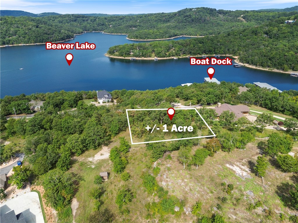 The perfect opportunity to own a stunning +/- 1 acre wooded lot in the highly sought-after gated community of Del Lago. Nestled in a private setting, this property offers breathtaking views of Beaver Lake and includes access to a boat dock and dedicated slip, making it an ideal location for building your dream home or a peaceful lake retreat. Utilities are conveniently available at the street, including electric, public water, and community sewer service exclusive to Del Lago. Residents enjoy the security and amenities of this well maintained subdivision with annual fees of $879 for the Del Lago POA, $135 for sewer, and $725 for the boat slip. Whether you are looking for a full time residence or a weekend getaway, this property combines natural beauty, modern conveniences, and direct lake access in one of Northwest Arkansas's most desirable communities.