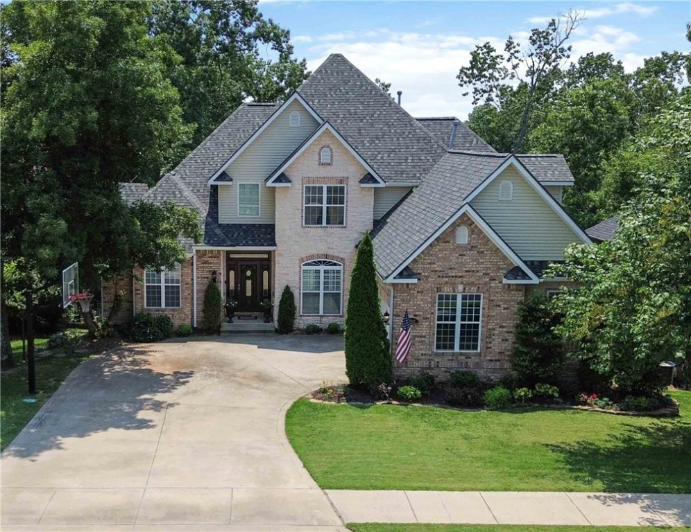 Nestled in comfort and convenience, this beautiful 5-bedroom, 5-bath home is only a few minutes to I-49, making your commute a breeze. Smart updates, including new lighting, updated paint, recently refinished real wood floors, and new carpet, mean this home is move-in ready and ready for you. The living room flows into the eat-in kitchen with an additional sitting room, creating a cozy area to visit with friends and family. Also on the main floor is a spacious primary suite & an additional bedroom, dining room, and laundry room. Upstairs has a large bonus space, 2 bedrooms, and 2 baths. Downstairs you will find an enormous family room with kitchenette, bedroom, and flex space. Outside there is a large back deck that overlooks a wooded surrounding, where a variety of birds visit often. New roof 2022, new appliances, rebuilt deck, and storage galore in this beautiful property you do not want to miss. Close proximity to new Walmart Campus, Crystal Bridges, bike trails, and Bentonville Square. Preferred lender credit.
