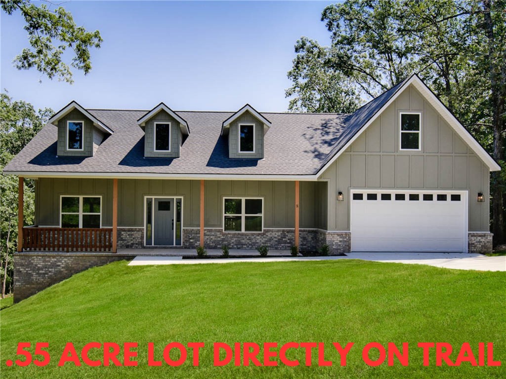 NOW OFFERING A 4.125% INTEREST RATE THROUGH THE BUILDER'S PREFERRED LENDER! Stunning new construction home on a large .55 acre wooded lot directly on Tunnel Vision Trail and just minutes from Lake Windsor! Only 15 minutes from downtown Bentonville! Features include a modern kitchen with floor-to-ceiling custom cabinets, a gas range, and luxurious 3 cm quartz countertops. Enjoy a flexible layout with 3 bedrooms (2 on the main level), a designated flex room, and an upstairs bonus room. The primary bath offers a luxurious retreat featuring an oversized custom tile shower and a large walk-in closet. Step outside to your huge stained deck with beautiful wooded views, perfect for entertaining or relaxing. Epoxy floors in garage! Bentonville schools!