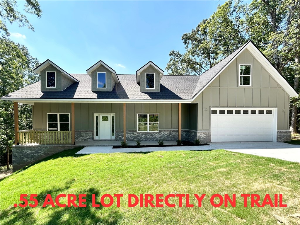 Stunning new construction home on a large .55 acre wooded lot directly on Tunnel Vision Trail and just minutes from Lake Windsor! Only 15 minutes from downtown Bentonville! Features include a modern kitchen with floor-to-ceiling custom cabinets, a gas range, and luxurious 3 cm quartz countertops. Enjoy a flexible layout with 3 bedrooms (2 on the main level), a designated flex room, and an upstairs bonus room. The primary bath offers a luxurious retreat featuring an oversized custom tile shower and a large walk-in closet. Step outside to your huge stained deck with beautiful wooded views, perfect for entertaining or relaxing. Bentonville schools! $3,500 towards buyer's closing costs when working with the builderās preferred local lender!