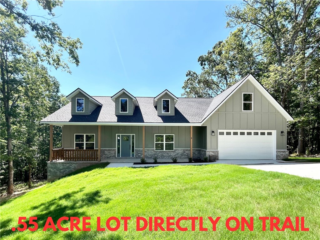 Stunning new construction home on a large .55 acre wooded lot directly on Tunnel Vision Trail and just minutes from Lake Windsor! Only 15 minutes from downtown Bentonville! Features include a modern kitchen with floor-to-ceiling custom cabinets, a gas range, and luxurious 3 cm quartz countertops. Enjoy a flexible layout with 3 bedrooms (2 on the main level), a designated flex room, and an upstairs bonus room. The primary bath offers a luxurious retreat featuring an oversized custom tile shower and a large walk-in closet. Step outside to your huge stained deck with beautiful wooded views, perfect for entertaining or relaxing. Epoxy floors in garage! Bentonville schools! $3,500 towards buyer's closing costs when working with the builderās preferred local lender!