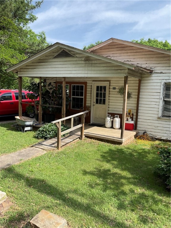 FIXER UPPER ON NEARLY AND ACRE-ENDLESS POTENTIAL!!! Situated on a spacious corner lot of 3/4 acre, this 2 bedroom, 1 bath home is full of potential for the savvy buyer or investor. The property features a large kitchen, perfect for future updates, and a covered back porch ideal for relaxing or entertaining. The entire back and side yards are fully fenced, making it great for pets, gardening, or outdoor living. Two separate storage buildings provide ample space for tools, hobbies, or equipment. With room to expand and customize, this property is a rare opportunity to create your dream home or investment on a generous lot.