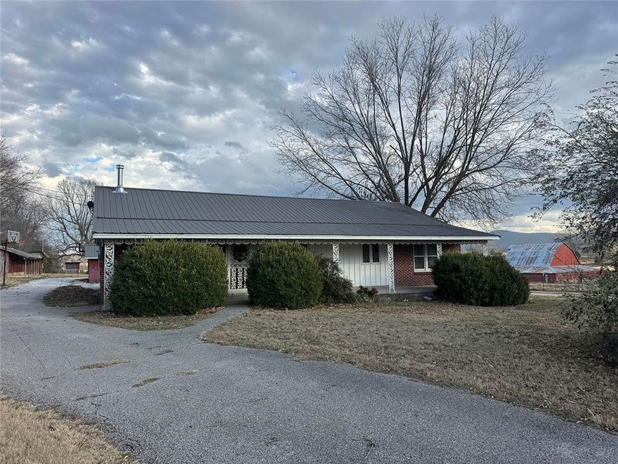 This 3-bedroom, 2-bath home sits on approximately 3 acres just minutes from Harrison, offering a comfortable country setting with the convenience of town nearby. The property features a spacious yard with fencing, making it ideal for pets, gardening, or simply enjoying the outdoors.

The home is equipped with both a wood-burning furnace and central HVAC, providing efficient heating options throughout the year. A durable metal roof adds long-term reliability and low maintenance.

Outside, the property includes a large barn and a separate workshop, offering plenty of space for equipment storage, hobbies, or small-scale projects. With open space, useful outbuildings, and easy access to town, this property offers a practical setup for those looking for a little extra room without being far from amenities.