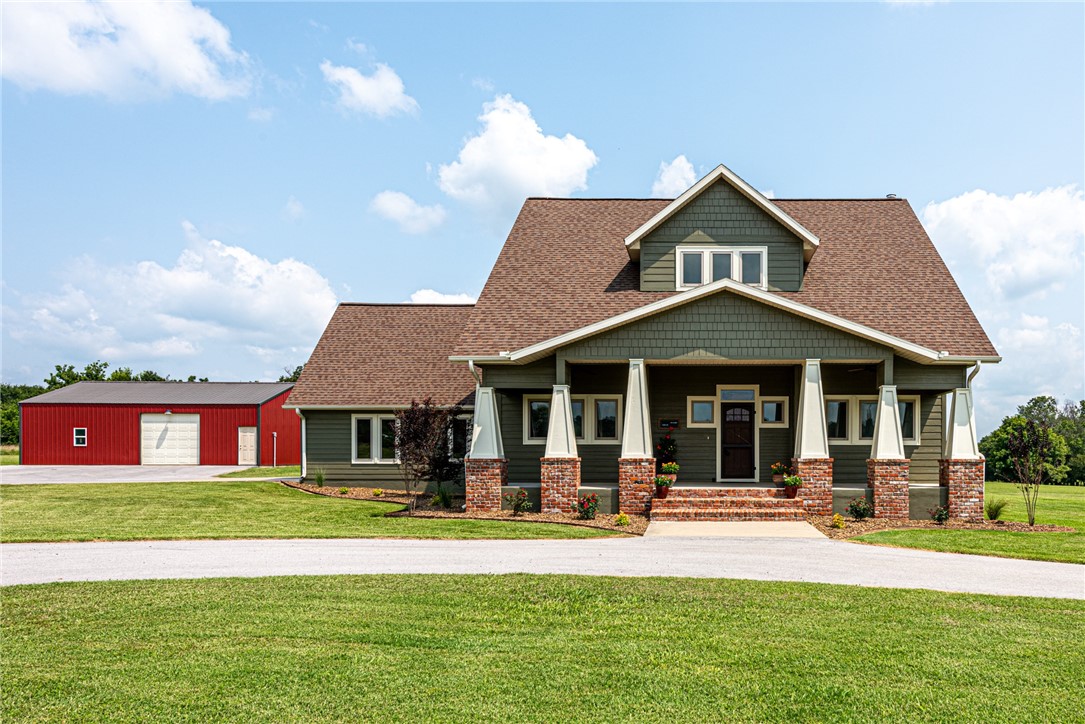 Luxury Country Living! Check out this gorgeous craftsman-styled home sitting on 5 acres in Farmington just minutes away from shopping, eateries, & Fayetteville! With 4 bedrms 3.5 bathrms, & a shop this is just what you have been looking for! From the paved driveway head up to the covered front porch & enjoy the view! Head inside to a semi-open floor as you flow into the living room featuring wood floors, a white-washed wood-burning FP, fresh paint, a large kitchen w/ white cabinetry, new wall paint, updated backsplash, kitchen island, stainless steel apps, & eat-in dining room! Also on the main level, an office space & large laundry room w/ built-ins & brick floor! Head upstairs to the master suite w/ tall ceilings, double sink vanity, soaking tub, & walk-in shower! Plus 3 more spacious bedrooms & an addition 2.5 baths! Bonus: A large upstairs attic space! Head out on the covered back patio & enjoy the scenery of the land! PLUS a 1200 sqft shop perfect for man cave, project area, or 2nd garage! Act now!