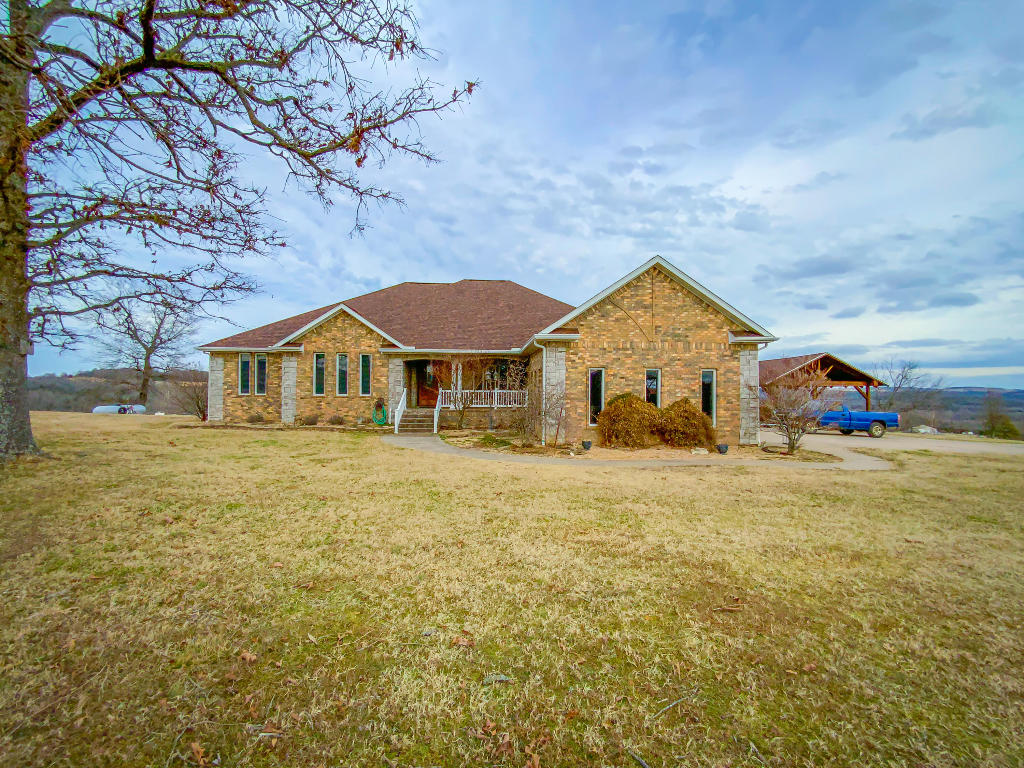 Spectacular home with good views in all directions! This custom home boasts beautiful hardwood flooring, custom cabinets and granite countertops. Living room features cathedral ceiling with gas log fireplace. Oversized master bedroom also features a huge master bath with jetted tub & big walk in closet! The two spare bedrooms upstairs features a Jack and Jill bathroom for added convenience. Basement den is massive for all of those large get togethers or to just relax. Basement also features a 4th bedroom, 3rd bathroom and a 2nd kitchen for additional family members to live in if needed. A storm shelter is also located in the basement for added safety. A 1200 sq. ft. basement garage/workshop gives you all the room you need for projects and lake toys! Yes, this property is More...