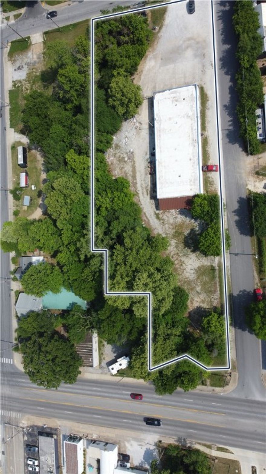 Amazing potential in a prime location with endless possibilities! This property is minutes from the University of Arkansas, Fayetteville Square, and adjacent to the Razorback Greenway. Versatile property that can used as an office, commercial warehouse, industrial space, or food beverage/music. Property is zoned Downtown General. The property neighbors the Tanglewood Branch Creek offering offering a unique amenity. Opportunity awaits!