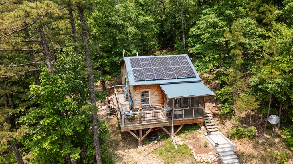 Off Grid Cabin in the Woods joining the Arkansas Game and Fish 15,000 ac Madison County, AR
1 mile to Rockhouse Boat launch.
Well-built cedar cabin move in ready. 840 sq. ft. Built in 2020. 1 bedroom with a loft. The Screen porch opens to sun deck, vaulted ceilings give an open airy feel to this lovey hidden gem of a cabin located in an Exclusive area of NW Arkansas. Spring water-gravity fed, Solar panels, batteries, propane tank and storage building convey. Spring fed creek along south border. Live off Grid in a recreational park.
The deck has Views of 15,000 acres of wooded Wilderness that changes with the seasons but not with development. Very private end of the road location. Bike, hike, fish, hunt, explore, kayaking, enjoy no light pollution and see the stars. Wonderful VRBO potential.
20 minutes to down town Eureka Springs or Huntsville AR.
Kings River Rockhouse access 1 mile, Trigger Gap access 3 miles.