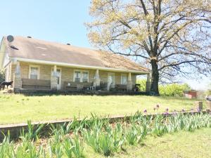 Large 2-story home in the country. Home on 5 acres. Nice Sandstone Rock home with 5 year old siding in the eves, large country kitchen, 6 Plum trees, 2 wells with sand filters and well houses, a huge Bartlett Pear tree, and a nice yard. 400 sq. ft. of open porches, outbuilding, garden spot, large trees,older home but in good condition with new plumbing in the kitchen and 15 year old roof. House Sold As Is.