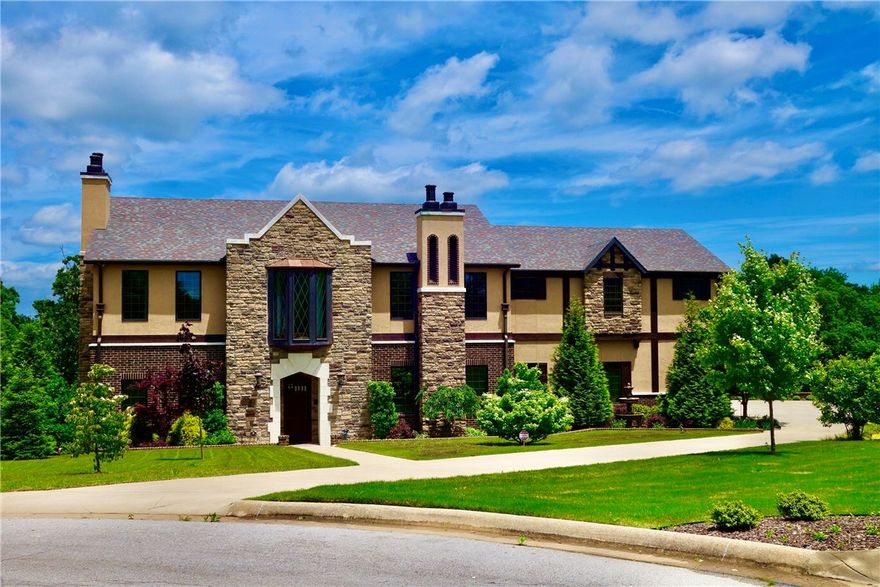 Gorgeous custom Tudor home, full of old-world charm with modern upscale amenities. Soaring 22' ceiling in kitchen, breakfast and family rooms. 6 x 9 island with cooper apron sink, 2 dishwashers, china storage, 6 burner gas stove with griddle; breathtaking woodwork and details throughout. Ample outdoor entertaining options, overlooking stunning salt water pool with copper waterfalls. Outdoor kitchen and oven, outdoor shower! Every bedroom has private bath. Home featured on HGTV's "House Hunters" season 178, "Building Battle in Arkansas" (2019).
