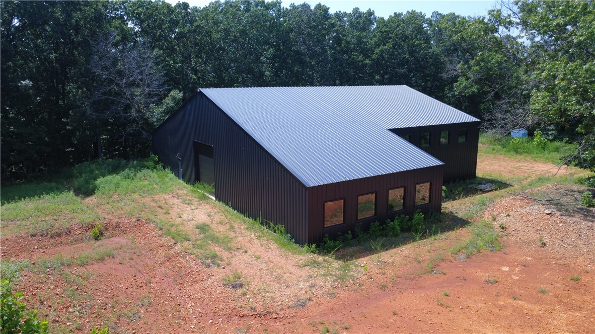 New construction warehouse/flex building ready for customization or finish-out under existing plans - plans include an office space, kitchen, full bath, laundry, and an open area for a potential showroom, workshop, or garage. Building was designed and constructed by Quality Metal Inc. 14'x14' drive in doors on each end, perfect for RV, small or large equipment. Shop area is equipped with 200-amp electrical service, while 100-amp service exists in other areas of the building. Septic system and plumbing have been installed, and water is provided by a 653' well with 10.5 ppm. Beautiful secluded location, ideal for a wide range of potential uses.
