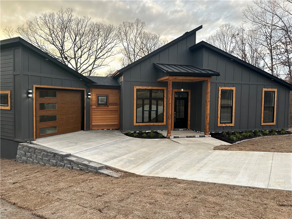 Experience luxurious living in the heart of Bella Vista,Arkansas in a quiet cul de sac just minutes from Highlands Golf Course and I-49! This beautiful modern-style home boasts sleek design with board and batten siding, high-end finishes, and panoramic views. With a spacious living area, gourmet kitchen, and a serene master suite, this residence is perfect for those seeking elegance and comfort. Enjoy the tranquility of the surrounding nature from the expansive windows and minimalist interior with natural light. Creating a spacious illusion, clever storage solutions and open layouts optimize the available space. Indulge in outdoor living on the stylish composite deck. Don't miss the opportunity to make this stunning property your dream home in Bella Vista!