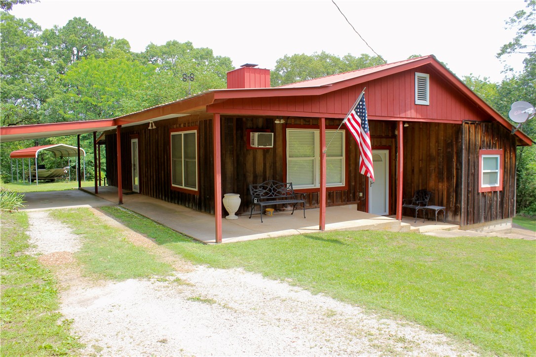 93+/- acre property 6+/- minutes from Eureka Springs. This property offers a blend of comfort, self-sufficiency, and natural beauty. The 1261+/- sqft 2 bed/1 bath home features cozy living spaces with serene views of the forest. No matter what your seeking this property delivers on every level. There's a spacious 1040+/- sqft shop and a 280+/- sqft greenhouse, ideal for growing your own produce. The storm shelter/cellar adds an extra layer of security and storage, ensuring peace of mind. To make this property even better there's an additional cabin perched on a point, offering breathtaking views of the valley below. The towering mature oak and pine timber creates a peaceful canopy, while the level areas provide ample opportunities for additional rental cabins or custom home build-sites. A well-maintained trail system winds through the property, leading to unique features like shelter bluffs, a tranquil pond, and even a fresh spring nestled in a small cave. Wildlife includes turkey, deer, and other small game.