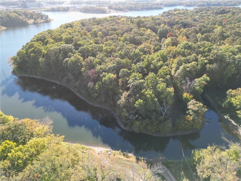 11+ wooded acres with over a 1300 feet of Swepco Lake frontage. This is beautiful and very private. Onsite well needed. Deer are plentiful and great fishing are just a few