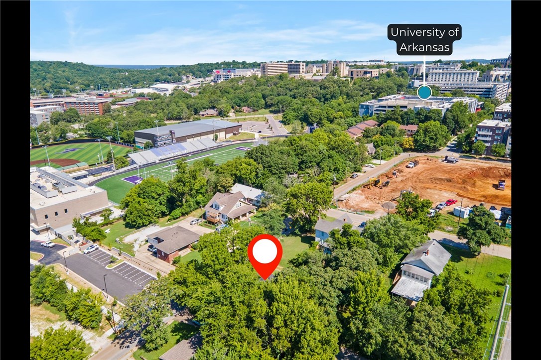 Exceptional opportunity to own a home and lot within walking distance to the University of Arkansas, Fayetteville High School, Walmart and steps away from the Razorback Greenway. Investor special or cash buyer alert! This RMF-40 zoned property sits in the heart of Fayetteville with unbeatable walkability and high redevelopment potential. Existing Structure-Built 1936, New HVAC (2022), New Windows (2023), New Roof (2023), 200 Amp Electrical Panel (2023) Some remodeling already completed — ready for your vision! Infill Prioritization Score: 12, surrounded by RMF-40 & Main Street Center zoning. Whether you’re looking to renovate or redevelop, this lot is a unique opportunity in the heart of Fayetteville!