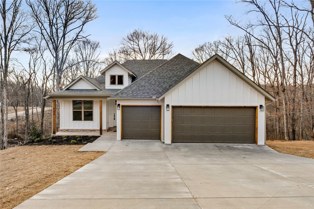 This home features an open floor plan, hardwood flooring throughout, custom cabinets and trim work with lots of storage and cabinet space, an oversized 3 car garage, a finished walkout basement with a second living area, a covered deck with lots of privacy. Just minutes from downtown Rogers. Move in today. The basement also features an unfinished space of 392 sq/ft that is not included in listed square footage. Note: all the property to the left of the house to the corner of Cardin and Oneida is part of this lot. Seller offering $10,000 towards buyer closing costs.