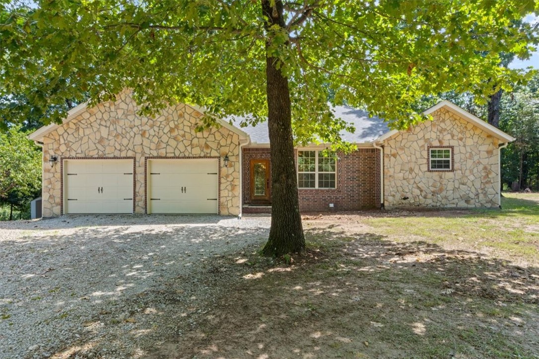 This custom-built country home blends comfort, functionality, and modern upgrades on a flat, park-like 1-acre lot. Built in 2007, the single-story, 2,692 sq ft home features 4 bedrooms, 2.5 baths, and an open floor plan with a spacious kitchen, stainless steel appliances, island, pantry, and dining area. A wood-burning stoveācapable of heating the entire homeāadds warmth and charm. The exterior features brick-and-stone construction, mature shade trees, a garden area, and a new wooden back deck wired for a hot tubāperfect for entertaining. A spacious attached garage adds extra storage and convenience. Located just a short distance from Hickory Creek Marina, this peaceful retreat is ideal for anyone seeking quiet, country living with modern amenities in the heart of Arkansas.