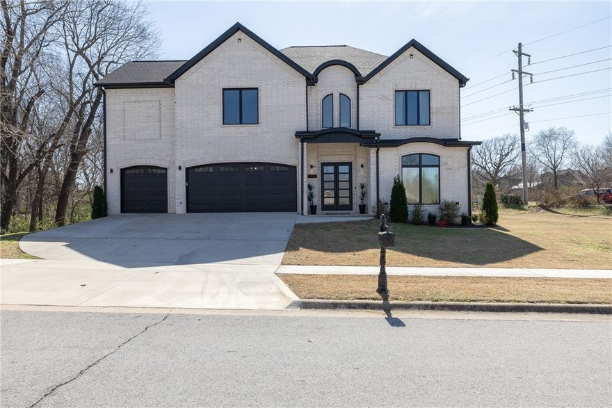 Like-new & beautifully maintained, this West Fayetteville home offers a clean, modern aesthetic with a functional open layout for everyday living & entertaining. Dedicated office with double door entry & built-in desk sits just off the entry, along with a convenient half bath. Beautiful tile flooring runs throughout the main living areas, connecting formal dining to the kitchen with granite countertops, gas cooktop, microwave, pantry & large waterfall island, opening to the breakfast area & living room, anchored by a gas fireplace. Second level includes a landing with built-in desk, bedroom with ensuite bath, two additional bedrooms & a full bath, plus a spacious primary suite with two walk-in closets & a spa-like bath with walk-in shower, soaking tub & dual vanity. Set on a 0.55-acre lot with tree preservation for added privacy, the home includes a covered patio for outdoor living. Neighborhood offers a pool & playground with easy access to I-49 and close to parks, dining, shopping & everyday conveniences.