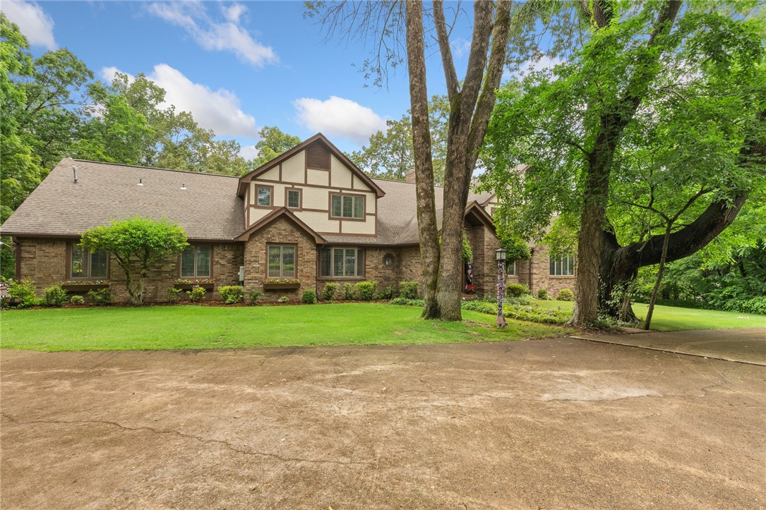 Welcome to your private retreat on 1.6 acres in one of Harrison's finest neighborhoods. This custom 7 BR/3 1/2 bath home offers 6979 sq ft of living space with soaring ceilings, spacious rooms, a chef's kitchen, and 2 living areas with a shared wood-burning fireplace. Features include a music and game room, an office with a Murphy bed, and a glass window enclosed porch with a hot tub for six. The upstairs boasts of 5 bedrooms with built-ins, including the primary suite with a private balcony. The basement has tons of storage and two additional bedrooms. Beautiful inground pool with expansive deck. Slate pool table and built-in TV in the swimming pool area and two microwaves convey. Pool and deck furniture convey.