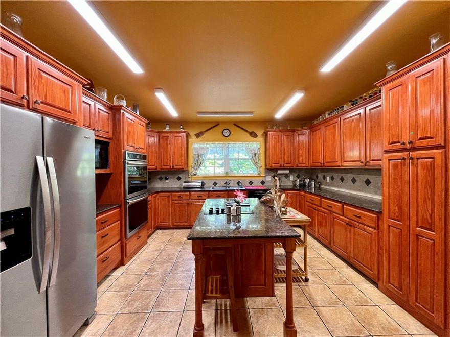 11.5 acres in the beautiful Ozarks! This custom home, built in 2006, situated on secluded wooded acres with a natural spring flows year round, offering views for miles from its back deck. The main floor comprises 3bed/2.5baths including one room currently used as an office with a half bath. A guest bedroom features its own private bath, while the primary bedroom boasts a jacuzzi bath, separate walk-in shower, and double vanity. A 492 sq ft basement includes 1bath & office/flex room.13x16 storm shelter used as bedroom.Steel fire door. A new generator providing emergency backup power. The property also features a 610 ft well with a new pump and tiles, a new double oven in the kitchen, a separate water heater for the kitchen, complemented by an 80-gallon water heater for the rest of the home. A 12x12 storage building and Ozarks Go Fiber Optic internet and cable services available. Approx 35-40 min commute to Fayetteville & Springdale, AR.