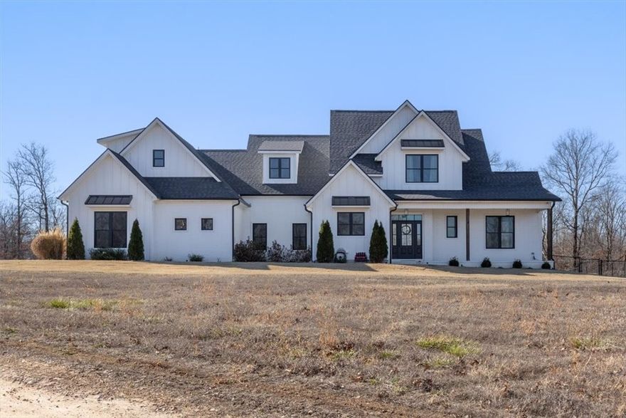 Tucked away on 8.24 private acres, this like-new Craftsman-style home blends timeless charm with modern luxury! Enjoy a 3-car side-entry garage, exterior lighting, professional landscaping, and a welcoming covered front porch. The backyard is an entertainer’s dream with a private in-ground pool and spacious patio already prepped for a hot tub. Inside, the open floor plan features vaulted ceilings, wood floors, and picture windows that flood the home with natural light. The chef’s kitchen boasts stainless appliances, a gas cooktop with pot filler, large eat-in island with storage, spacious pantry, under-cabinet lighting, and flush-mounted cabinetry. Relax in the stunning primary suite with trey ceiling, private patio access, and spa-like bath. The main level also includes a large laundry room with sink and cabinetry plus a flex room ideal for an office or gym. Upstairs offers a guest suite with private bath and two additional bedrooms with a full bath on the opposite wing