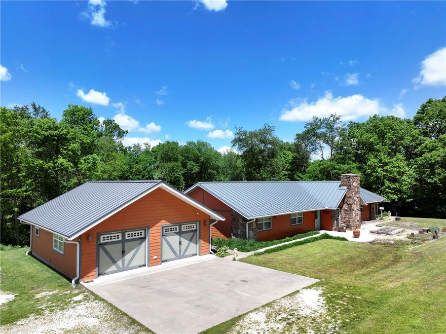 Welcome to your dream property located minutes from town on 5 spacious acres. This well-designed home blends comfort and functionality with a standing seam metal room, new septic system in 2019 offering peace of mind. The kitchen is equipped with built-in oven, gas cooktop range, trash compactor, with plenty of cabinet space for storage. Enjoy the dedicated spaces like the sunroom, private office and media closet for your home office or entertainment needs. Two zone on-demand water heaters ensure efficient and endless hot water. The outdoor space is just as impressive, with an entertainment ready porch and pavilion ideal for gatherings. The 16X20 barn with electric offers extra storage or workshop potential, while the 2-car garage is plumbed for compressed air- perfect for hobbyists or mechanics. This property offers space, privacy and versatility that is a rare find.