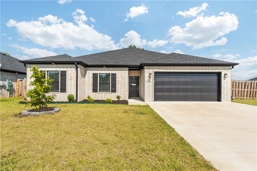Nestled on a corner lot just steps from Pop Allum Park and biking trails, this 2022-built home is only one mile from downtown Gravette & 20 miles from the new Walmart Home Office. The open-concept floor plan features a welcoming living room with a gas fireplace that flows into an eat-in kitchen with granite counters, gas cooktop, walk-in pantry, & a spacious island with bar seating. The split-floor plan design provides privacy, with two guest rooms on one side & the luxurious primary suite on the other. The primary retreat includes a spa-like ensuite with dual vanities, soaking tub, walk-in shower, and an expansive closet. Outside, enjoy your private, fully-fenced backyard that features a newly installed tile patio & ambient lighting--perfect for gatherings, cookouts, or relaxed evenings under the stars. Additional features include luxury vinyl flooring throughout, energy-efficient appliances, & leased solar panels for monthly savings. This home is move-in ready & designed for convenient everyday living.