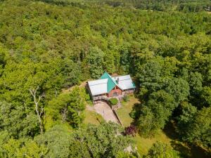 Ready to get away from all the hustle and bustle? Come home to this beautiful setting! A 2,234 sqft home secluded on 3.2 acres with a cabin life feel. The wrap-around deck lets you enjoy the beauty surrounding you and your home. Relax and unwind in your own swim spa! Inside, no detail was left out with a Natural rock fireplace, vaulted ceilings, 3 bedrooms, 2 bathrooms with a loft that could function as a 4th bedroom or office area. The Master bath has a walk-in shower and step-in jetted tub.