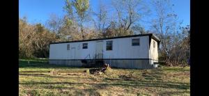 There are plenty of opportunities here with this singlewide on 1.43 acres m/l just off the highway close to Valley Springs School. The back of the lot levels off nicely & there may be an opportunity to stack more homes on this lot. All #'s are approx., age is estimate, sq. footage per assessor, buyer to verify existence of septic. Selling AS-IS.