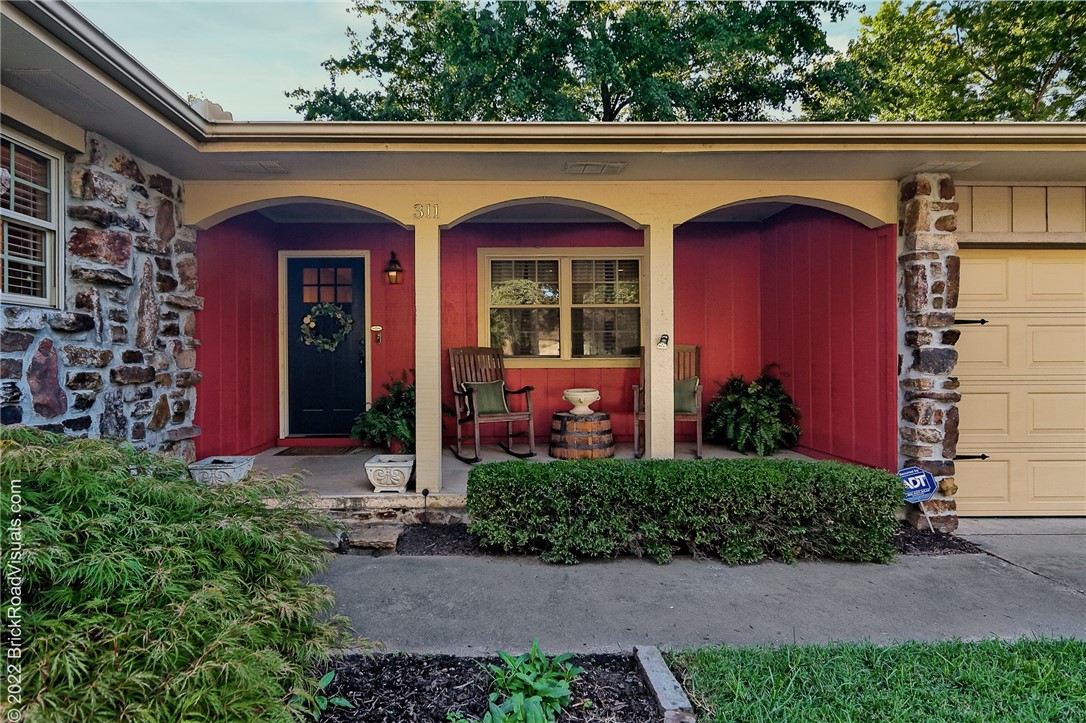 Homes near Bogle Park rarely come up for sale! This one-level home is nestled along a quaint and quiet street in Downtown Bentonville just steps from the Square, trails, parks, shopping and restaurants. Beautiful native stone and a cozy front porch will welcome you to this 3 bedroom 2.5 bath home situated on a large irrigated and professionally landscaped lot. The spacious and renovated kitchen has an induction range, granite countertops, large island, coffee bar and an abundance of cabinet storage. Ideal for entertaining, this home boasts two living areas one with a fireplace and both with easy access to kitchen. Features include hardwood floors throughout most of the house and brand new carpet in the bedrooms. The primary bedroom hosts en-suite bath, three closets for storage and lots of natural light. A truly spectacular home in the heart of Bentonville!