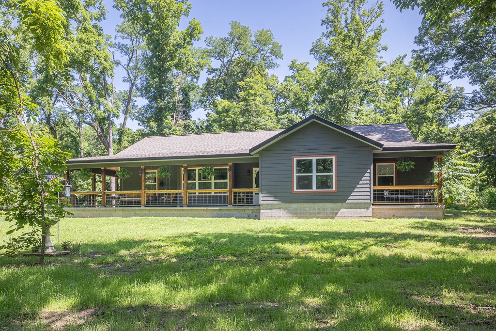 Custom-built 2023 home on private 1.65 acres! Nice private & peaceful country setting. Only 5 miles to the Lost Bridge Beaver Lake access & boat ramp! Sturdy 2x6 exterior wall construction! Beautiful kitchen with high-end counter tops & gas range & oven. Vaulted ceiling in the living room with a wood stove to keep your family warm and cozy in the winter months. The primary bedroom has 2 walk-in closets & a private covered patio perfect for reading or enjoying coffee in the morning or an iced tea in the afternoon. The primary ensuite bath has a claw-foot soaker tub, walk-in shower, and double vanity. The house was designed to be a 3-bedroom, and the current oversized 2nd bedroom can be reconfigured for a 3rd bedroom. Beautiful covered front porch to relax & enjoy the country scenery. Back patio for grilling. Oversized garage with a workshop area. RV parking with septic/power hookups. Large vegetable garden. Storage shed. Access to community pool & clubhouse. Approx 20 minutes to Rogers. A great place to call home!