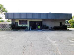Exceptionally designed medical office with 8 separate offices, 2 Testing Rooms, 3 Exam Rooms, Laboratory, Large & Medium size conference rooms, X-Ray Room, Large Lobby & Reception Office, 2 Bathrooms and ample warehouse space in back of this 5,000 square foot metal building. This building sets on a large commercial lot with ample parking in front of the building on the North side and additional parking located along the West side of the building. The East side of the Lot is fenced for business vehicles and equipment. The entire floor plan is attached hereto as well as a Survey to the Lot. This building and site are move-in ready for a medical office or related business. All interior office space is heated and cooled.