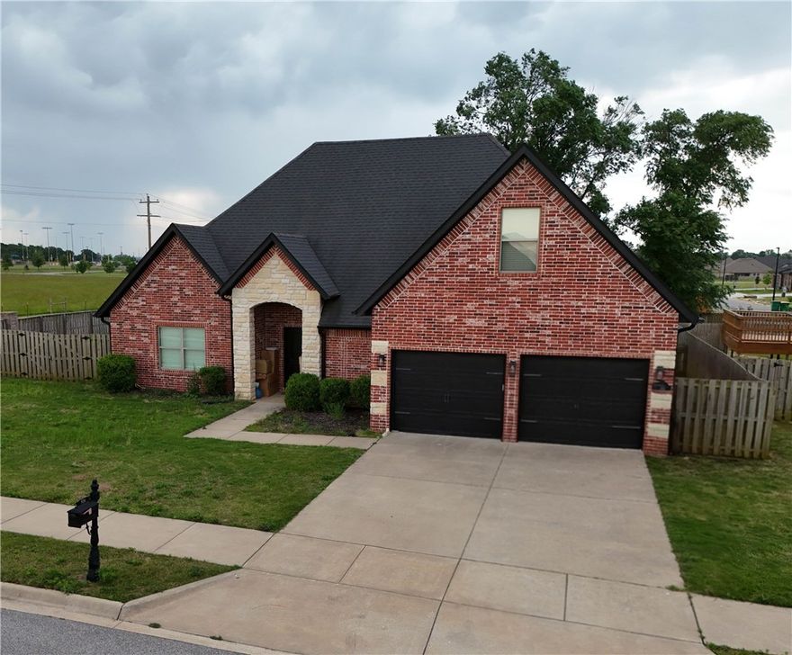 More pictures coming soon! Located in the highly sought-after Sunrise Ridge subdivision, this stunning all brick and stone home offers style, comfort, and convenience! Situated on a spacious 0.32-acre corner lot with a huge flat, fully fenced backyard with room for a pool. The open floor plan features wood-look tile flooring throughout the main level, abundant natural light, and a modern rectangular gas fireplace as the centerpiece of the living room. The kitchen is perfect for entertaining with granite countertops, stainless steel appliances, pantry, gas range, and designer lighting. Main level includes 3 spacious bedrooms and 2 full bathrooms, including a luxurious primary suite with double vanity, fully tiled walk-in shower, jetted tub, enclosed toilet area, and oversized walk-in closet. Upstairs offers a large bonus room with half bath. Enjoy the covered patio, outdoor fireplace, and custom gas fire pit. Close to Bentonville West schools, parks, trails, shopping, and dining!