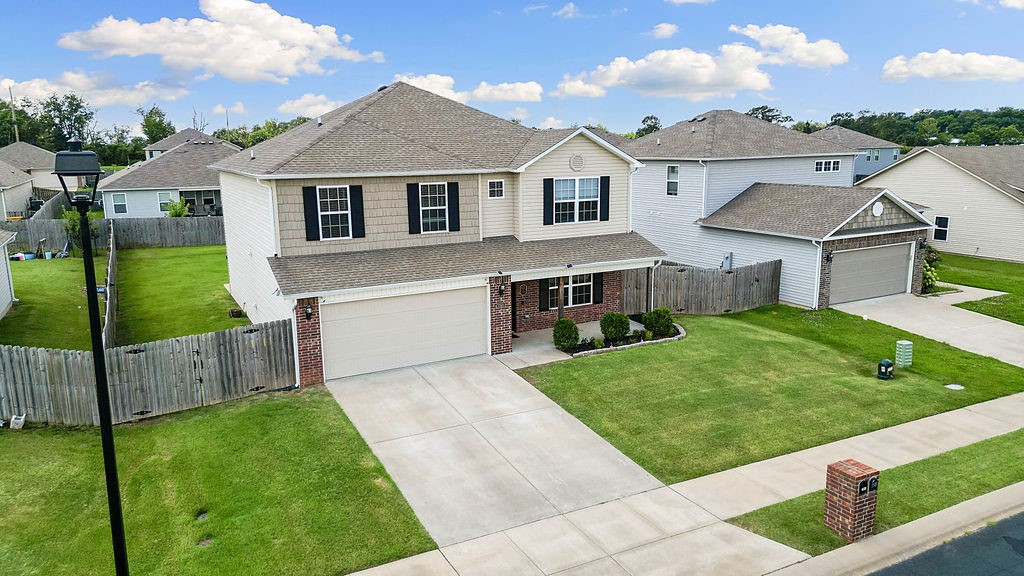 Welcome to the Lakewood Subdivision in Lowell! Perfectly situated near Pinnacle Hills shopping, dining, and easy access to I-49. The home is just minutes from a popular Elementary School and local parks. This spacious 2,664 sqft home offers 4 bedrooms, 2.5 baths, and a versatile bonus room upstairs. Ideal for a playroom, home office, or media space. The open concept living and dining areas provide ample room for entertaining or everyday comfort. Step outside to a large, fenced backyard complete with a patio, oversized umbrella, and garden bed.
