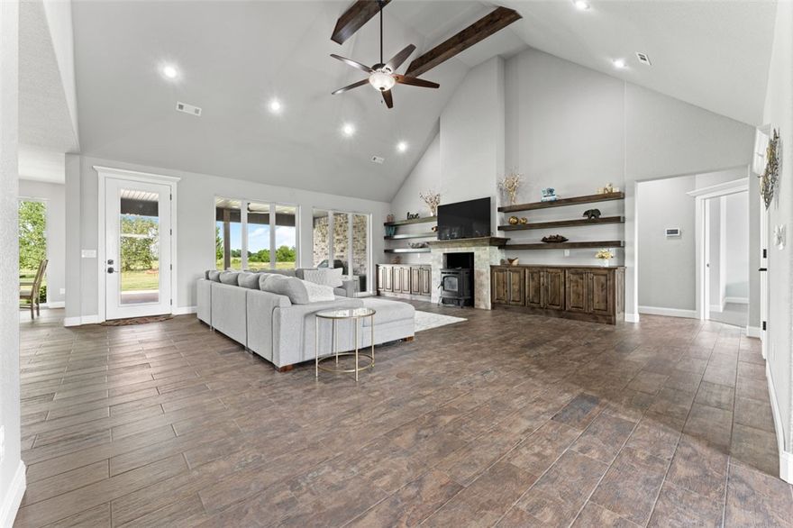 Don't wait to picture yourself enjoying this beauty! 12 fully fenced, peaceful acres at the edge of town, yet convenient to Downtown Bentonville! This custom built home welcomes you with such great curb appeal and a circle driveway with plenty of parking and an extra deep 4 car garage! Once you get inside the house you'll be amazed by everything you see. Spacious living areas flow together for perfect entertaining or relaxing. Superb natural light through many picture windows bathes the space with a friendly cheer.  The custom design shines out, including 4 oversized bedrooms with large closets (plus a home office), unique granite counters and all the storage and closets you could want(including 2 walk-in pantries)! In addition, this amazing layout offers the best laundry room you've ever seen and a large bonus room. This brick home is so efficient the utilities are less than many homes half its size. City water, 3 hvac systems, and a fantastic pellet stove in the living room! Call today for your private showing!