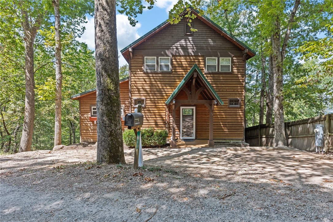 This charming, furnished lakefront home has a peaceful, short walk down to coveted āEmerald Cove.ā Enjoy Beaver Lake views from most rooms throughout this custom-built cedar home featuring an open floor plan with 3 bedrooms, 3 bathrooms, stone gas fireplace, handmade moldings, stained glass accent windows, hardwood and slate flooring, granite countertops, custom energy efficient blinds, & jacuzzi bathtub. This home is perfect for entertaining inside and out with a private fenced backyard & access to multiple decks & sitting areas to enjoy the lake view. Fantastic location near the dam, Honey Creek, & 15 minutes from Eureka Springs.Starkey Marina is right around the corner, so boat over to the gravel beach below your house! Home has a new metal roof in 2022 and new HVAC syetems.All furnishings and items in the house convey.