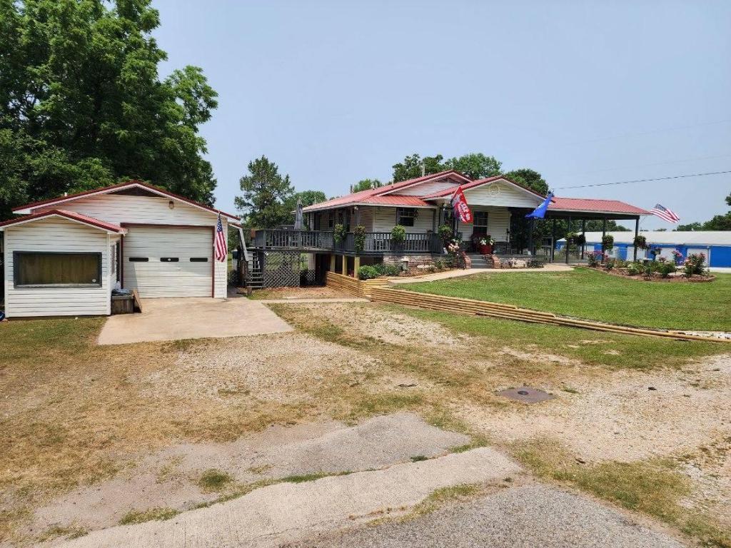 Great location for this home with shop. New Carrier Heating and Cooling 24 KW whole house Generac, metal roof on home & sheds 3 years ago. New flooring 1 yr ago. New ceiling fans, light fixtures & paint 1 yr ago, Home is handicap accessible, including stair lift. Sheds are 12x20 & 8x16. Shop has electric & is heated with office space & 1/2 bath. Great location for home/business on Hwy 7.