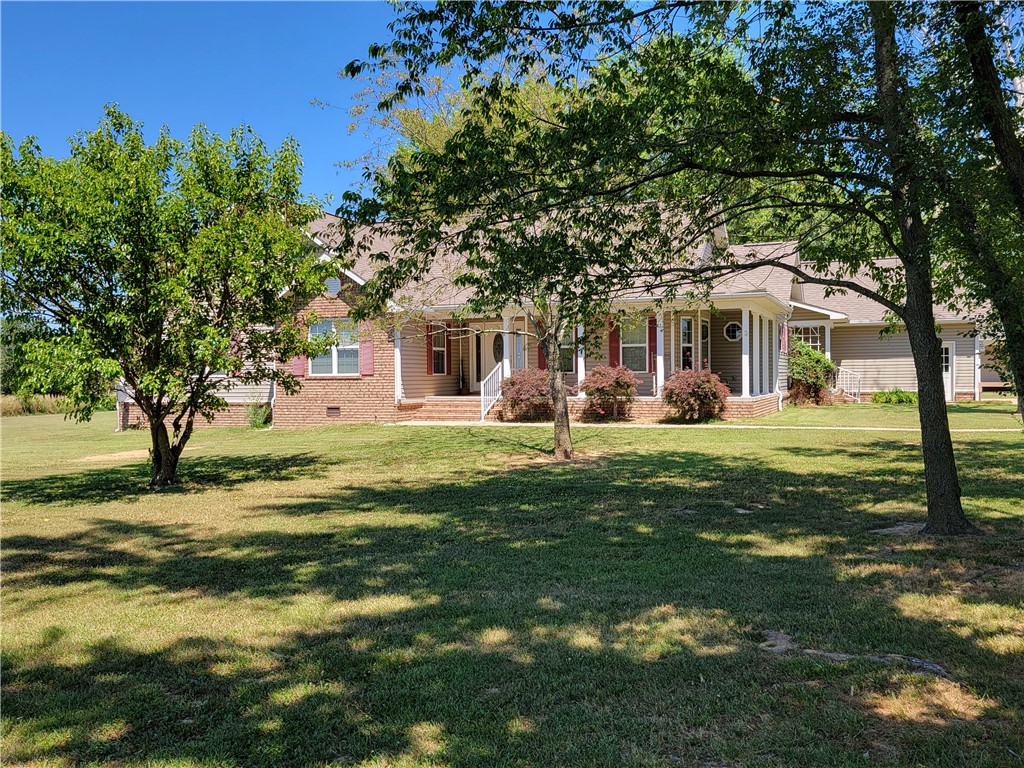 Beautiful 2468 sq ft home with 800 sq ft guest house on 5 acres! Turn in on the paved circle driveway with 5 level acres. 3 bedroom 2&1/2 bath gas fire place, sun room, dinning room, wood & tile floors, granite counter tops, large finished storage or hobby room above garage, Large 2 car garage with storm shelter, portable generator connection. Have morning coffee watching horses run on the 5 acres on the large covered back porch or a glass of wine in the evening on the covered front porch, Sit around in the evening making smores! A beautiful 800 sq ft 1 bedroom guest home, with kitchen, living room, bed room, utility room 1 bath, large front porch and covered back deck. This place also has a 30x50 shop with cement floors, and elect. Another 25x12 enclosed out building with cement floors, can be used for horse stalls or equipment storage. Many more amenities! This is a must see. Great location. New roof in 2022. Call for an appointment today.