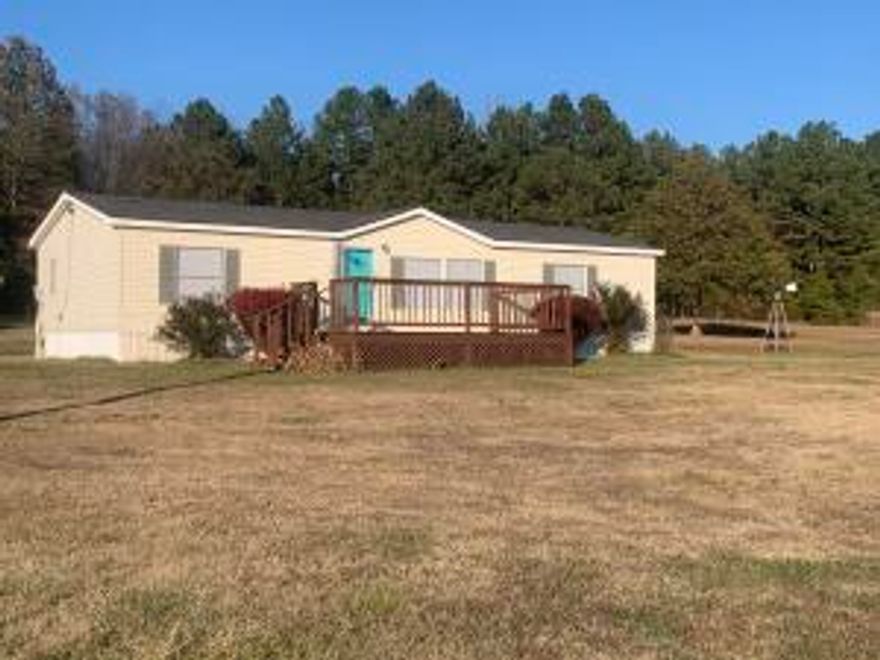 Take a look at this charming 3-bedroom, 2-bath country home on a peaceful 4 acres. The front porch is perfect for relaxing and enjoying the view of the spacious yard and pond. The backyard has lots of space for a garden and it even has a chicken coop! The storage building would be perfect for tools, equipment or even a she-shed. The metal/iron carport is sturdy and large, perfect for entertaining.                                                     Inside, the home has had fresh paint, new ceiling fans and blinds.  Spacious open floor plan in the living room, dining room and kitchen. The dining room has ample cabinetry for lots of storage and even a coffee bar. The bedrooms all have walk in closets for even more storage. This home is move in ready!