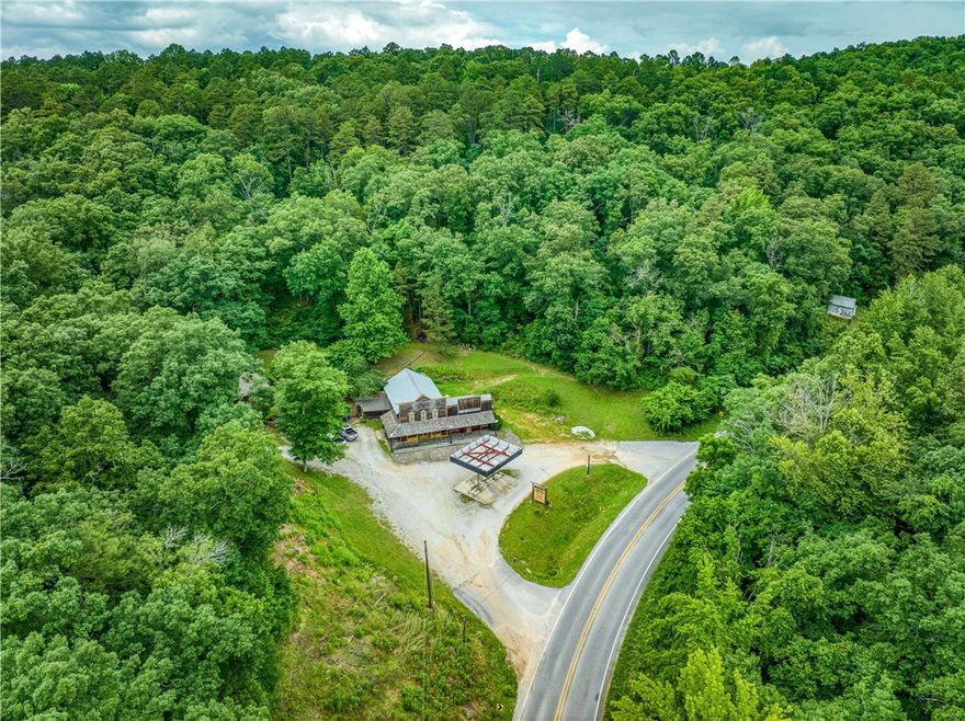 Incredible investment opportunity on 4.69 acres bordering the Ozark National Forest on two sides in beautiful Newton County, Arkansas—less than 3 miles to Jasper and within 5 miles of three Buffalo River access points. This unique property offers five potential income streams: a retail space with two offices, a recently updated 2 bed/1 bath apartment above, and two nightly rental cabins with strong occupancy rates. Property also features 2 shops/ storage spaces. A 4-sided billboard also provides additional passive income. Perfect for investors or those seeking a scenic live/work setup with built-in revenue in the heart of the Ozarks!