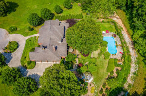 Stunning estate property ideally located on almost 3 acres offers stylish sophistication yet is so warm and inviting, offering spaces for large gatherings of family and friends. Custom built with exceptional quality throughout. Lush landscpaing, beautiful gardens and vibrant ornamental plantings create an enchanted setting for the lovely inground pool and outdoor kitchen. Inside, the stunning two story entrance has a beautiful curved staircase, and the interior finishes are incredible w/ maple hardwoods, turkish tile, and travertine...the ''cook's kitchen'' features granite, and fabulous custom distressed cabinetry, Wolf appliances, sub zero refrigerator, and double ovens. This unique home is a must see. List of amenities in ''documents''. NOW PRICED AT 699,900!