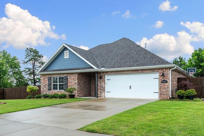 Nearly new West Springdale home has been meticulously maintained and features upgrades throughout. Featuring a split floor plan, this home has 3 bedrooms, 2 full bathrooms, and upstairs bonus room. Kitchen has ceiling-height, soft-close cabinets, quartz countertops, large farmhouse sink and over-sized island. Large living room with gas fireplace and high ceilings is open to the kitchen and dining area. The primary bedroom has an awesome accent wall and large windows. The primary ensuite has generous counter space, a whirlpool tub, and attached walk-in closet. Two guestrooms each have a walk-in closet. This home has generous storage options- large walk-in kitchen pantry, walk-in storage closet in the front hallway, understairs storage with built-in shelving, and a storage closet in the laundry room. Enjoy the covered patio that overlooks a tree-lined back yard with no rear neighbors! Storage shed conveys. Home is conveniently located near the I-49 corridor, Arvest Ball Park, and minutes from Shaw Park.