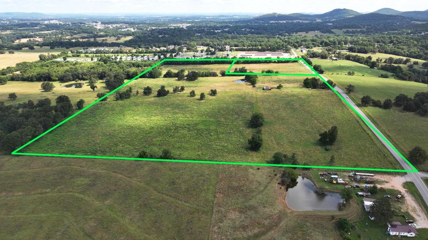 INVESTMENT OPPORTUNITY! 60 ACRES, 10 in city limits and 50 outside city limits ready to develop. Land has Highway 21 Frontage and is mostly flat and cleared. Would make an ideal location for a new sub-division or great place to build your dream home with livestock and land to roam just minutes from downtown Berryville with all the amenities and just touching the city limits. Property has a pond and currently, has lots of pasture.