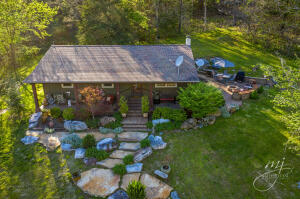Very nice home w/ 20 acres m/l in the Bergman School District. You will love the the picturesque setting, wildlife, privacy and gorgeous creek that runs through the property. The home is private, but not far off the main road. The landscaping is gorgeous, and the stone patio with firepit overlooking the creek and beautiful front yard is perfect for entertaining. There is also a spring on the property. The home features 2 bedrooms, 2 baths,office, open kitchen /living room with large windows to enjoy the view. Central Heat and air, on demand water heater. Home is in good shape, but being sold as is. Don't miss seeing this place, they are hard to find! Water heater is on-demand and uses gas to heat but needs electricity for the pump.