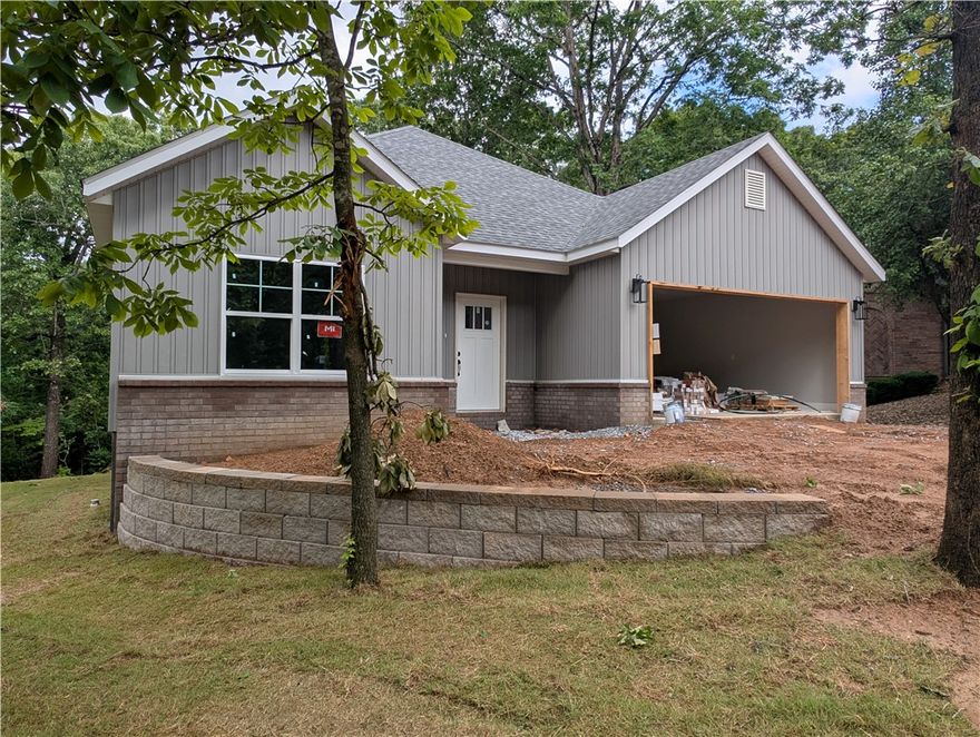 Discover modern comfort in this brand-new Hillington floorplan home, perfectly situated on a quiet cul-de-sac in beautiful Bella Vista, Arkansas. This thoughtfully designed 3-bedroom, 2-bath residence offers 1,688 square feet of stylish living space, featuring an open-concept layout, spacious bedrooms, and quality finishes throughout. Enjoy peaceful surroundings, new construction peace of mind, and convenient access to all the natural beauty and amenities Bella Vista has to offer. Ideal for those seeking both tranquility and modern living.