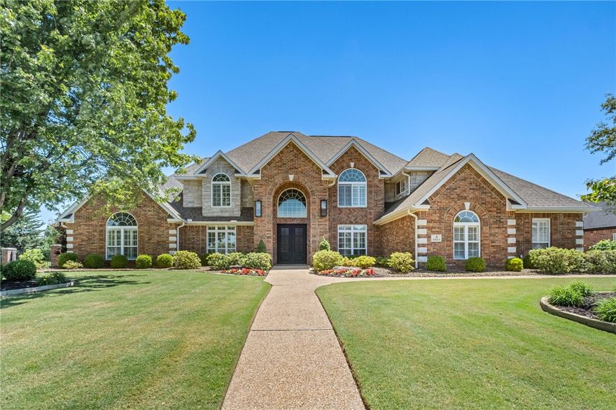 This beautifully updated residence in the prestigious gated community of Pinnacle Country Club offers an exceptional blend of timeless elegance & modern comfort. Spanning approximately 4,450 sq ft, the home features 5 bdrms, 4 full baths, & 1 half bath with thoughtfully designed living spaces ideal for both everyday living & entertaining. A dramatic great room showcases soaring cathedral ceilings & fireplace, while the gourmet kitchen is beautifully appointed w/marble countertops, double ovens, & an inviting eat-in dining area. Additional interior spaces include a formal dining room, private study, & spacious second living area offering flexibility for guests or recreation space. Situated on a beautifully landscaped 0.60-acre lot, the outdoor living experience is equally impressive with a sparkling pool & spa, outdoor kitchen, & fireplace designed for year-round enjoyment. Completing the property is a desirable side-entry 3-car garage, all within one of Northwest Arkansas’ most sought-after golf course communities.