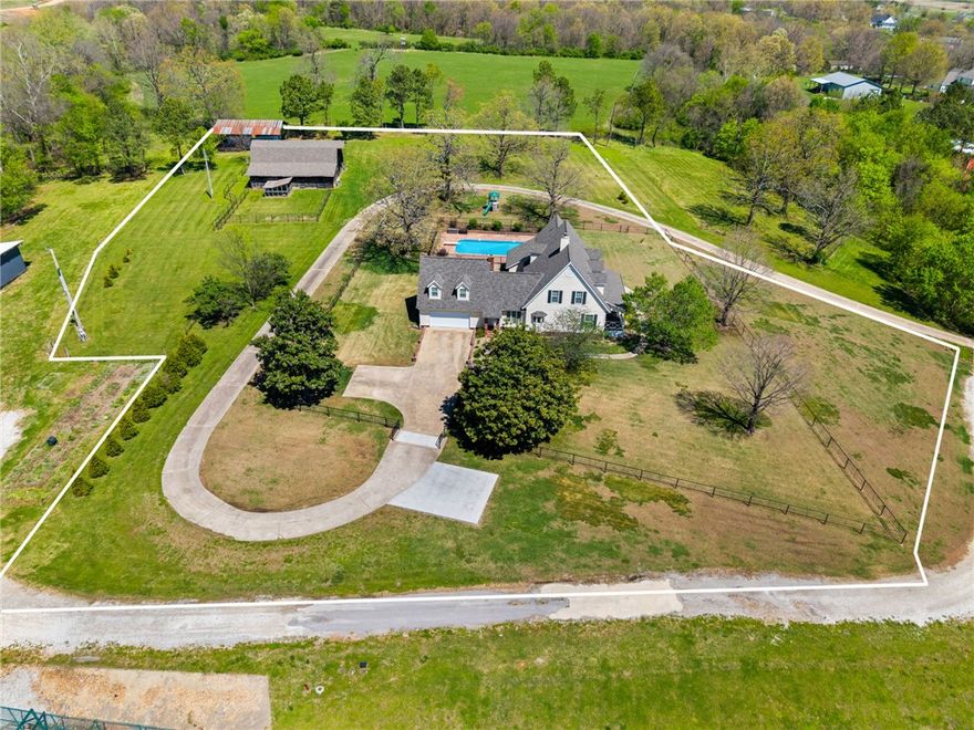 Offering $20,000 in credit or to be using for closing costs/prepaid.  A Fayetteville farmhouse like no other! This dream property rarely comes available and is truly one of a kind. Situated on 3 beautiful acres, this stunning 3,997 sq ft home features 4 bedrooms and 4.5 bathrooms, offering the perfect blend of space, comfort, and charm. Enjoy peaceful evenings on the front porch watching breathtaking sunsets and experience wildlife right in your own backyard. The property also includes a pool and an incredible barn that can be used for storage, hobbies, or animals. The home has been meticulously maintained with numerous upgrades throughout, making it move-in ready for its next owner. Experience the tranquility of country living while being just 10 minutes from everything Fayetteville has to offer—shopping, dining, and entertainment. Come see this exceptional property for yourself!